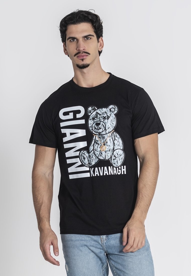 Crna majica s grafičkim dizajnom medvjeda s srebrnom teksturom. Na majici je u afričkim slovima ispisano "GIANNI KAVANAGH" u debelom bijelom fontu.