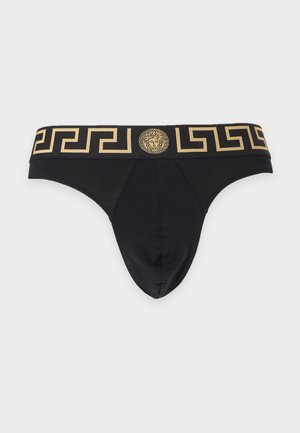 Caleçons noirs pour homme avec une ceinture à motif clé grecque dorée et un emblème central tête de Méduse sur un fond clair uni.