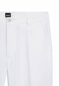 White linen pants featuring a button closure, front pockets, and a clean, tailored design. Tag displays the brand "BOSS."