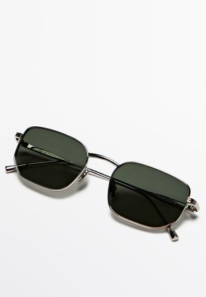 Occhiali da sole rettangolari neri con lenti verde scuro, montatura metallica argento, design a doppio ponte e aste sottili con piccoli dettagli.