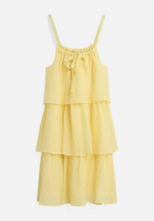 Robe jaune à étages sans manches avec fines bretelles et un nœud noué à l'encolure froncée, en tissu léger et texturé.