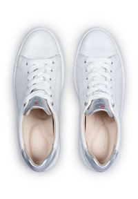 White leather sneakers with silver accents, featuring lace-up design, textured surface, and a smooth interior lining.