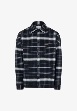 Camicia in flanella di cotone a quadri blu navy e bianco con colletto, chiusura con bottoni e piccolo logo verde sulla tasca a sinistra del petto.