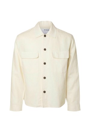 Camicia di lino off-white con chiusura a bottoni, due tasche sul petto, colletto classico e bottoni marroni. Maniche lunghe con polsini a bottoni.