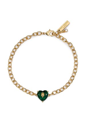 Złota bransoletka z łańcuszka z zielonym kamieniem w kształcie serca, ozdobiona złotym kwiatowym motywem na środku. Posiada zapięcie w kształcie karabińczyka.
