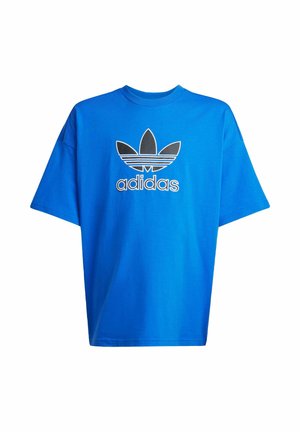 T-shirt bleu oversize à manches courtes avec logo trèfle Adidas noir et blanc et texte "adidas" centré sur le devant.