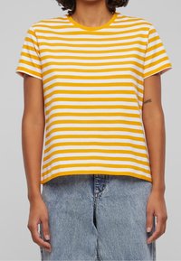 Yellow and white striped short-sleeve t-shirt made of soft cotton, featuring a crew neckline and a relaxed fit.