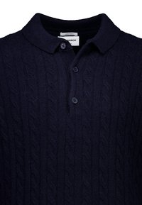 Navymarinefarbener Lambswool-Polohemd mit strukturiertem Kabelstrickdesign, drei Knöpfen und klassischem Kragen. Weicher und warmer Stoff.