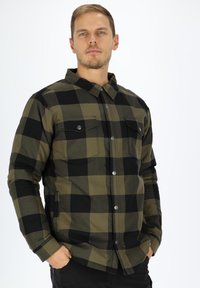 Checkered flannel shirt in black and olive green, featuring two chest pockets, a button-down front, and a classic collar design.