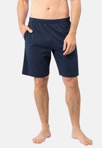 Shorts en coton bleu marine avec taille élastique et poches latérales, dotés d'une coupe ample et d'une texture lisse pour le confort.