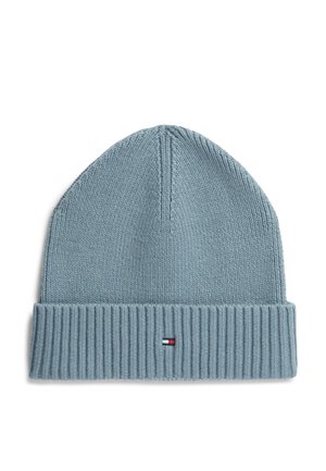 Light blue knit beanie with folded ribbed cuff and a small rectangular logo in red, white, and navy on the cuff center.