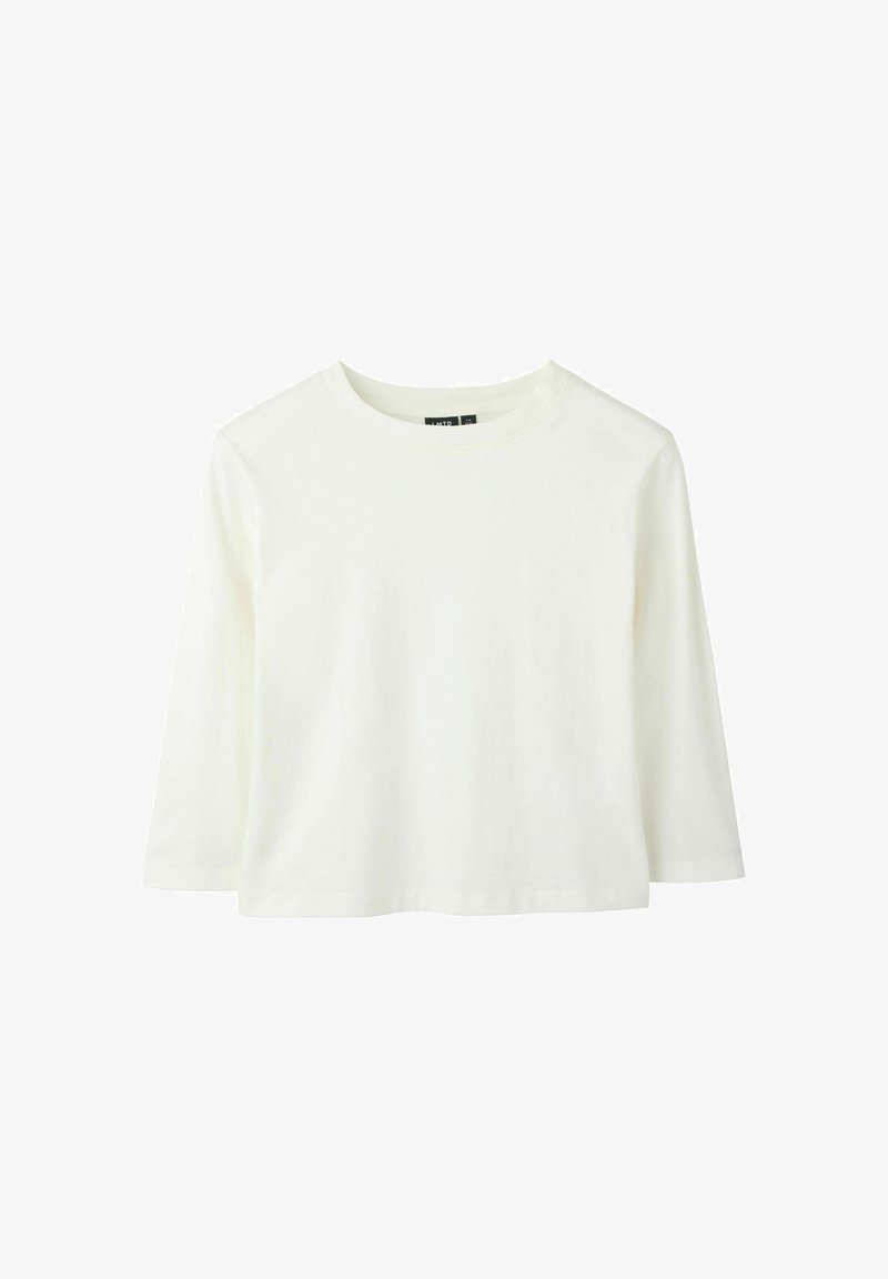 Haut court blanc uni à manches longues avec encolure ronde, présenté sur un fond blanc.