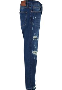 Jean skinny en denim bleu foncé avec des détails en détresse. Présente des déchirures et des ourlets effilochés, un design à cinq poches et une étiquette en cuir au dos.