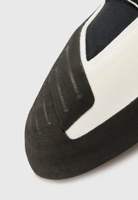 Climbing shoe with a rubber sole and textured black upper. Features a white leather accent and a fitted heel for performance.
