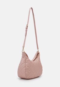 Quilted pink shoulder bag with a curved shape, adjustable strap, and gold hardware. Made of smooth leather with a zip closure.