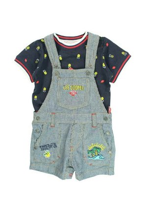 Salopette en denim rayé avec des motifs brodés, associée à une chemise bleu marine ornée d'imprimés colorés. Agrémentée de boutons-pression et de coutures.