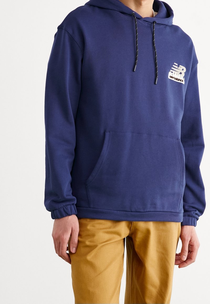 Navy blue sweatshirt with a hood, drawstring, front pocket, and elastic cuffs; features a logo with text on the left chest area.
