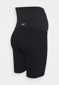 Black ribbed biker shorts with a high waistband and an embroidered logo on the back. Made from stretchy, breathable fabric.