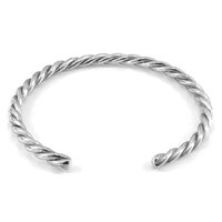 Twisted silver cuff bracelet, featuring a smooth, reflective surface with a spiral design and open ends for adjustable fit.