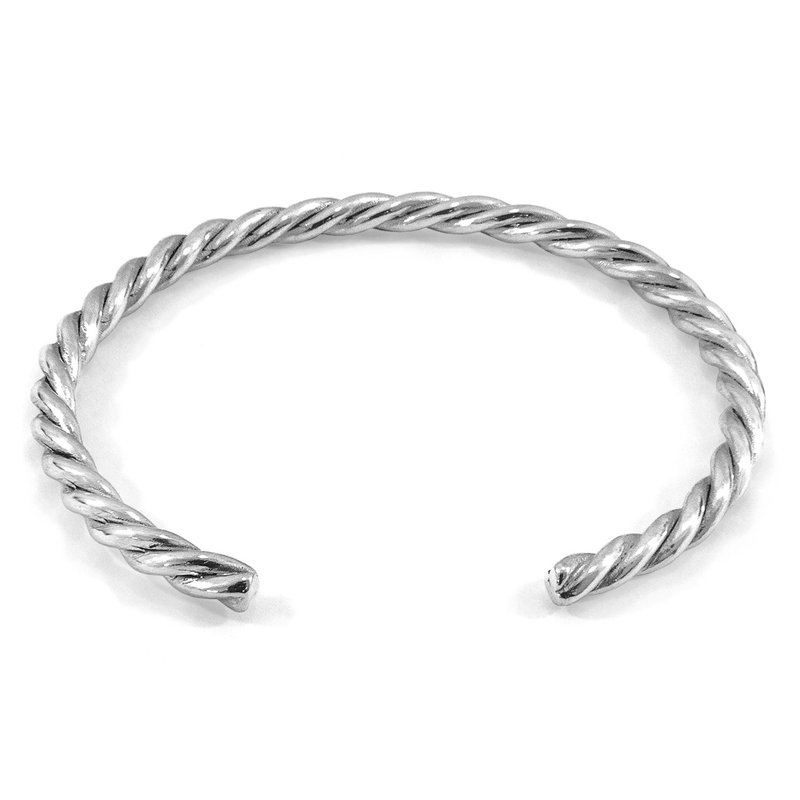 Twisted silver cuff bracelet, featuring a smooth, reflective surface with a spiral design and open ends for adjustable fit.