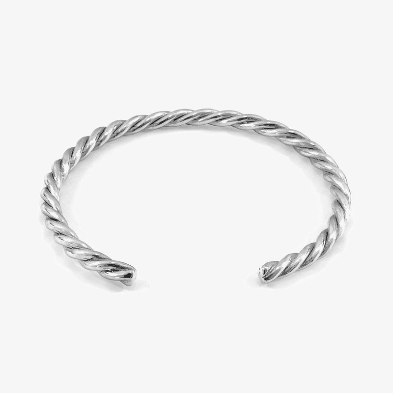 Twisted silver cuff bracelet, featuring a smooth, reflective surface with a spiral design and open ends for adjustable fit.