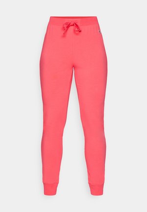 Lyserøde sweatpants med elastik i taljen og snøre. Tætsiddende ved anklerne med ribbede manchetter. Glat stof uden synlige mønstre eller accenter.