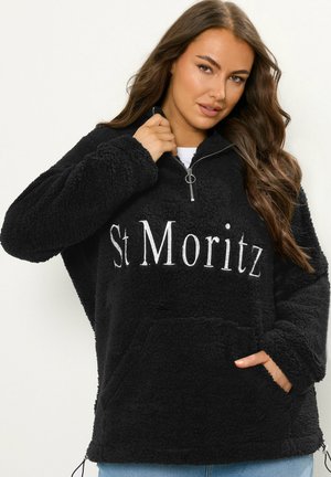 Pull en polaire noir avec demi-fermeture éclair, poche avant et "St Moritz" brodé en blanc. Tissu doux et texturé avec une coupe décontractée.