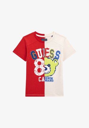 Red and white cotton t-shirt, split design featuring "GUESS" and a colorful bear graphic. Emphasizes soft texture and bold colors.