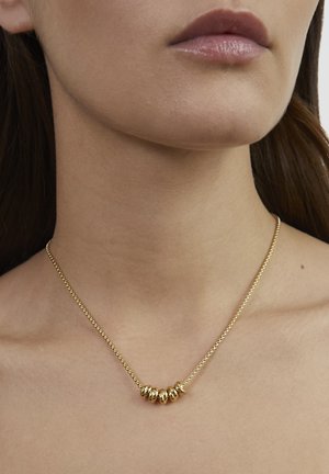 Goldkette mit dünner Gliederkette, die einen Cluster aus glatten, abgerundeten Perlen zeigt. Die Oberfläche ist poliert und erzeugt einen glänzenden Effekt.