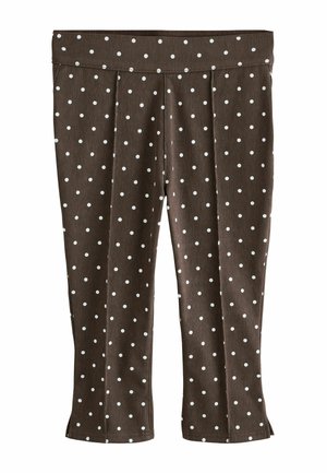 Brune cropped bukser med hvide polkaprikker, der har en bred linning og små slidser i siden ved kanten.