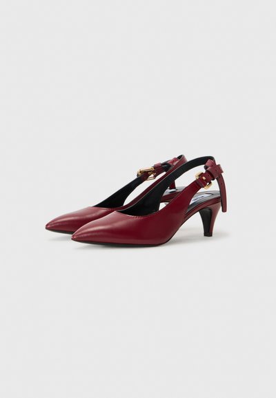 Maroon leather slingback shoes with pointed toes, a low heel, and adjustable strap featuring gold hardware accents. Soft, smooth texture.