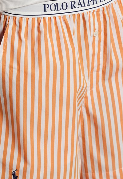 Męskie szorty w paski w kolorze pomarańczowym i białym, wykonane z bawełny, zapinane na guziki, z elastycznym paskiem w talii oznaczonym marką "POLO RALPH LAUREN".