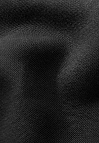Black fabric with a smooth, slightly textured surface, showcasing fine weaves. The overall appearance is uniform without any visible patterns.