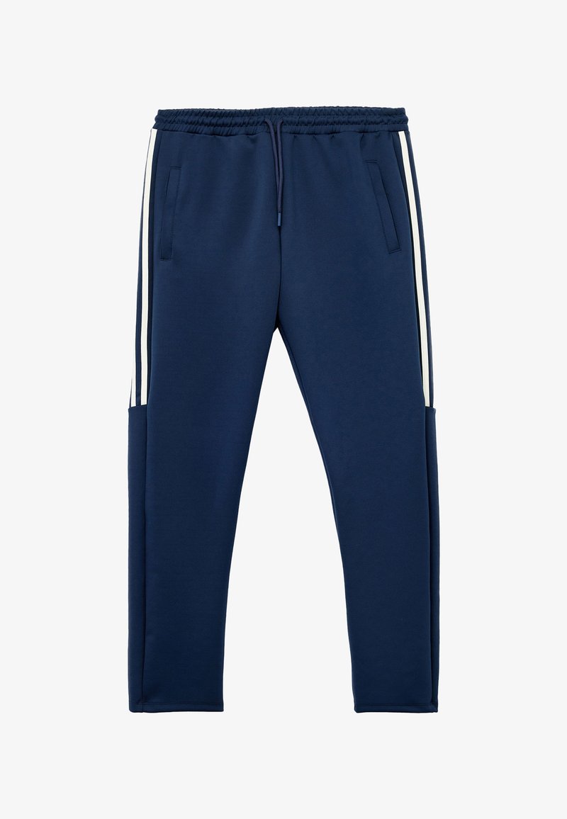 Marineblaue Sweatpants mit einem elastischen Bund, Kordelzug, zwei Seitentaschen und weißen Seitenstreifen. Hergestellt aus einem weichen, strukturierten Material.