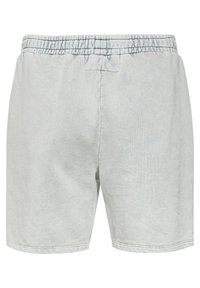 Světlé šedé bavlněné šortky s elastickým pasem, plochými švy a volným střihem. Vyznačují se hladkým povrchem a jednoduchým designem.