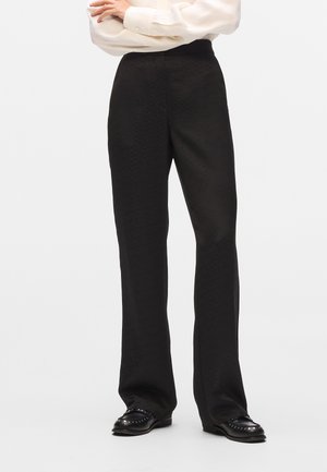 ALL-OVER-PRINT - Pantaloni - black