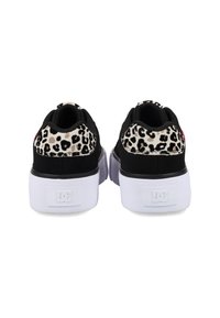 Black sneakers with leopard print accents, padded collar, and white rubber sole. Features DC logo on the heel.