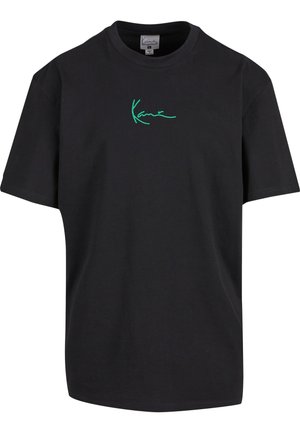 T-shirt en coton noir à manches courtes et col rond. Présente un graphique signature vert "Kanye" sur le devant. Dos uni et coupe décontractée.