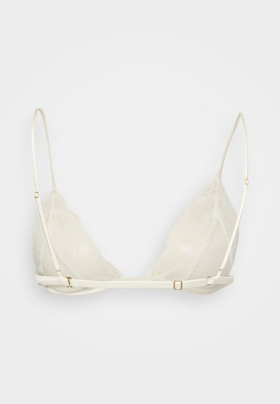 Bralette triangolare in pizzo color crema, con sottili spalline regolabili e dettagli in metallo dorato. Design in pizzo testurizzato con dettagli in rete.