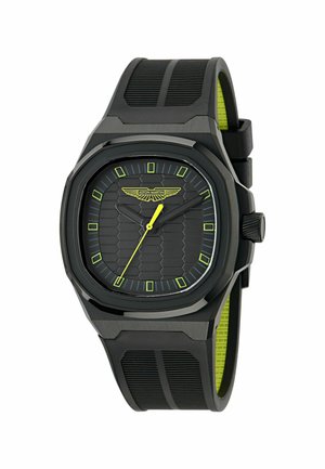 Black watch with hexagonal textured dial and yellow accents. Features a silicone strap, octagonal case, and luminous hour markers.