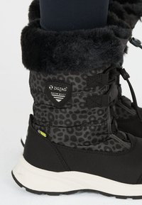 Schwarze Schneestiefel mit einem Leopardenmuster-Oberschenkel, einem Kunstfellbund und robusten Gummisohlen. Zu den Merkmalen gehören verstellbare Schnürsenkel und ein Markenlogo.