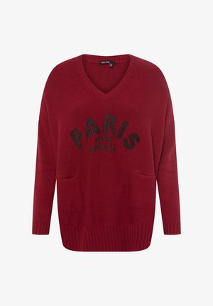 Red v-neck sweater with long sleeves, featuring two front pockets and a black sequined text print: "PARIS MON AMOUR" in a curved design.