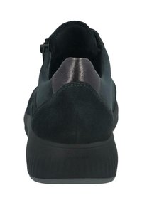 Black sneaker viewed from the back, featuring suede material, a leather heel patch, and a thick textured sole.