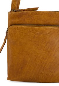 Brown leather crossbody bag with front zipper pocket, embossed "VENEZIA" logo, and stitched detailing.