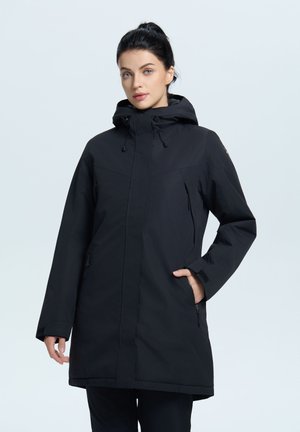 Chaqueta negra impermeable con capucha, cremallera frontal y bolsillos laterales. Presenta mangas largas, un corte recto y cordón ajustable en el cuello.
