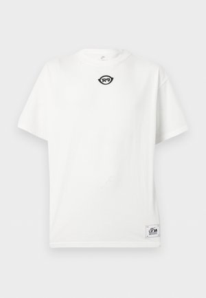 T-shirt blanc à manches courtes avec petit logo noir "R9" près du col et patch rectangulaire "dna" sur l'ourlet inférieur à l'avant.
