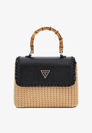 Handbag with woven tan body, black leather flap with stitched edges, bamboo handle, and metallic Guess logo on front flap.