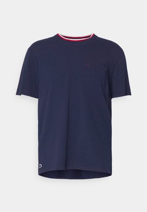 Navy short-sleeve t-shirt with a round neckline, contrasting red and white collar, a chest pocket, and a small logo near the hem.