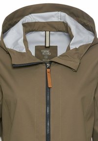 Olive green jacket made of recycled material. Features a zippered front, grey lining, adjustable hood, and brown leather zipper pull.
