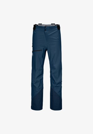 Navy waterproof pants with a relaxed fit, featuring black zippered pocket, two front buttons, adjustable suspenders, and contrast lower leg panels.